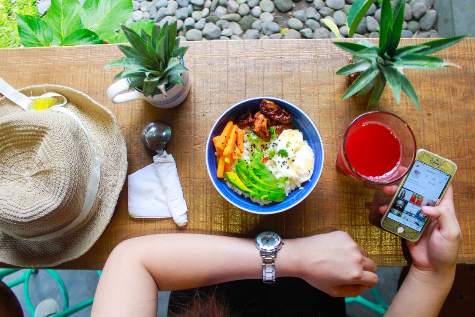 Woman enjoying a healthy meal while checking her phone