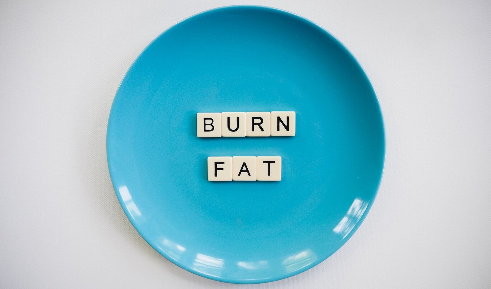 Conceptual image with the words Burn Fat on a plate