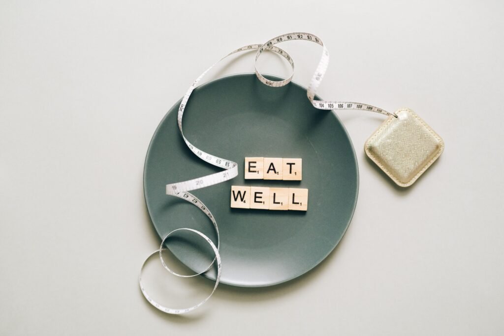 Eat Well tiles on a plate with a tape measure, representing what breaks a fast