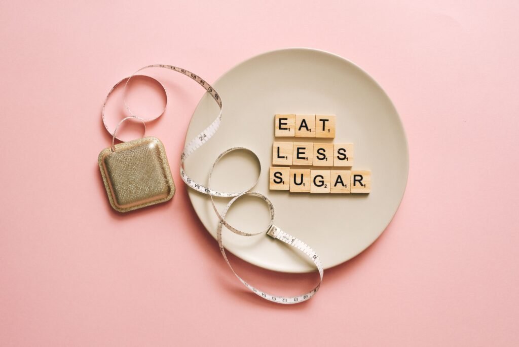 Eat Less Sugar scrabble tiles on a plate with a tape measure